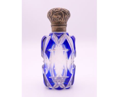 A silver topped blue and clear glass scent bottle.  7 cm high.