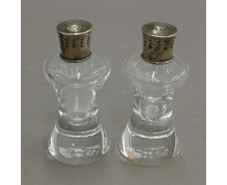 A pair of silver topped Steuben cruets. 11.5 cm high.