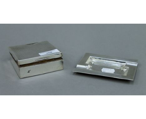 A silver ashtray, a silver vesta and a silver cigarette box. The ashtray 11 cm wide.