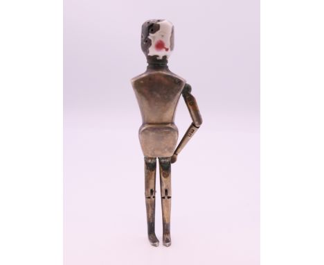A silver and enamel peg doll form pepperette, inscribed Frank Hyams Ltd, 128 New Bond St, W.  10.5 cm high. 41.3 grammes tota