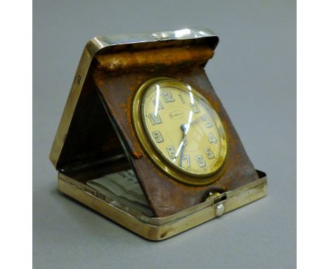 A silver cased travelling clock. 9 cm square.