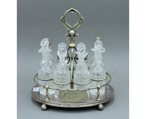 An eight piece silver plated cruet stand. 35 cm high.