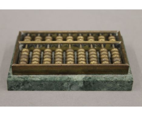 A small brass and green marble abacus. 8.75 cm long.