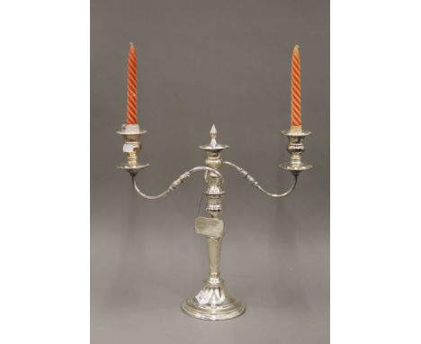 A silver plate three branch candelabra. 38.5 cm high.
