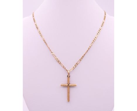 A 9 ct gold cross pendant on a 9 ct gold chain.  Cross 3.5 cm high, chain 46 cm long. 7.3 grammes.