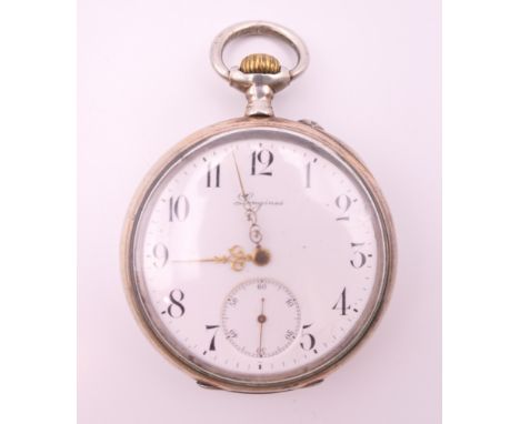 A silver Longines pocket watch.  5 cm diameter.