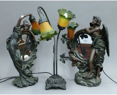A pair of figural mirrored table lamps and another lamp. The latter 58 cm high.