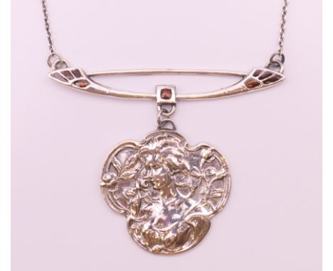 An Art Nouveau style silver pendant.   5 cm high including bar above pendant.