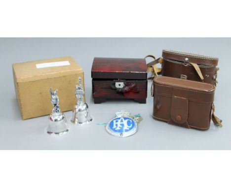 A gas mask, binoculars, two silver plated bells, etc.