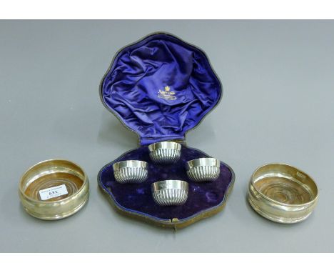 A pair of silver coasters and a boxed Mappin &amp; Webb four piece silver cruet set.