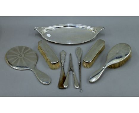 A silver dressing table set, a silver tray, etc.