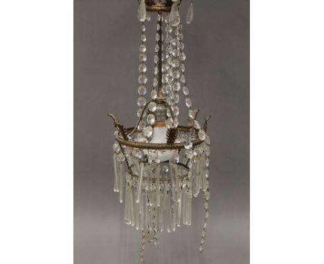 A brass and cut glass chandelier. Approximately 60 cm high.