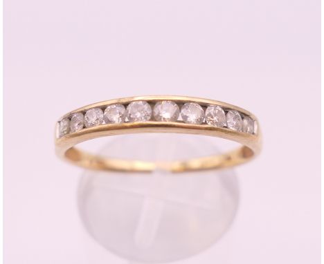 A 10 K gold diamond channel set ring. Ring size U/V. 2.2 grammes total weight.