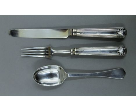 A silver knife, fork and spoon in a case. 