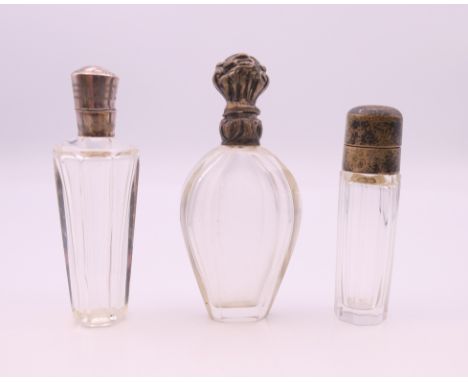 Three French silver topped scent bottles.  Tallest 9.5 cm high.