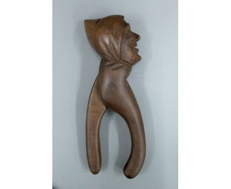 A late 19th/early 20th century figural carved nut cracker. 22 cm high.