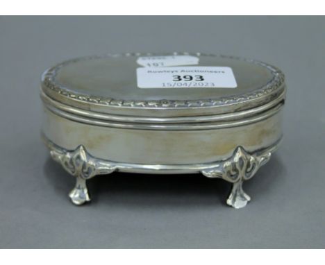 A small silver trinket box. 10 cm wide.