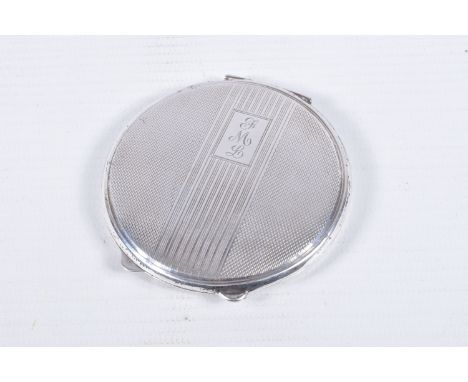 A SILVER COMPACT, of circular outline with engine turned decoration and central banded detail with engraved initials, silver 