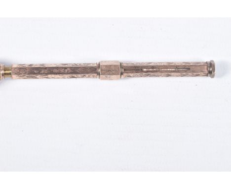 A YELLOW METAL PROPELLING PENCIL, detailed with a floral pattern, personal engraving reads 'J.M X-MAS 1892', sliding mechanis
