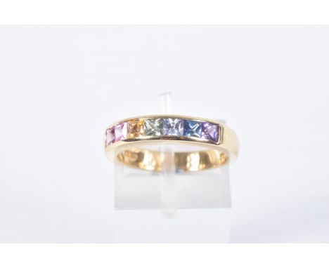 AN 18CT GOLD MULTI GEM RING, set with seven square cut gems in a channel setting, including sapphire and ruby, 18ct hallmark 