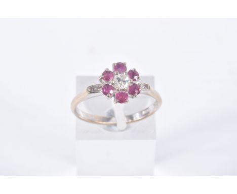 A YELLOW METAL, DIAMOND AND RUBY CLUSTER RING, flower cluster set with a central round brilliant cut diamond, estimated diamo