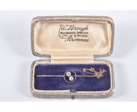 A YELLOW METAL DIAMOND BAR BROOCH, polished bar with open work centre piece set with two old cut diamonds, each milgrain set,