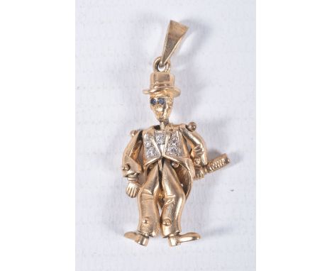 A 9CT GOLD ARTICULATED MAN PENDANT, gentlemen holding a bottle with top hat on, set with blue paste eyes and cubic zirconia j