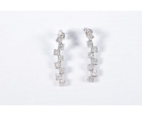 A PAIR OF 9CT WHITE GOLD DIAMOND DROP EARRINGS, each earring set with a row of illusion set round brilliant cut diamonds, est