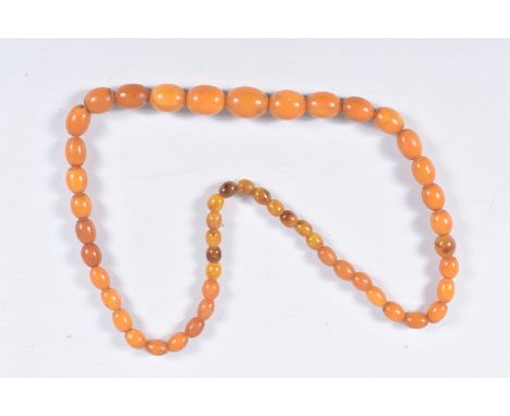 AN AMBER BEAD NECKLACE, designed as a single row of graduating oval beads, largest bead measuring approximately length 20.2mm