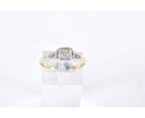 A DIAMOND RING, designed as a round brilliant cut diamond within a square setting with diamond detail to the shaped shoulders