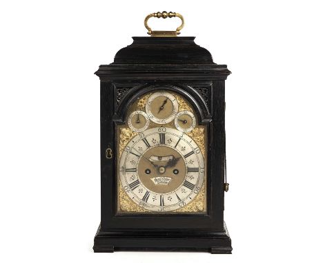 An 18th century ebonised bracket clock, the break arch brass dial with silvered Roman chapter ring, stylised fleur-de-lys hal