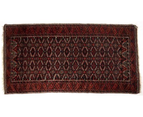 An early 20th century Balouch red ground rug with diamond motifs 99cm x 191cm and middle eastern red ground rug 121cm x 168cm