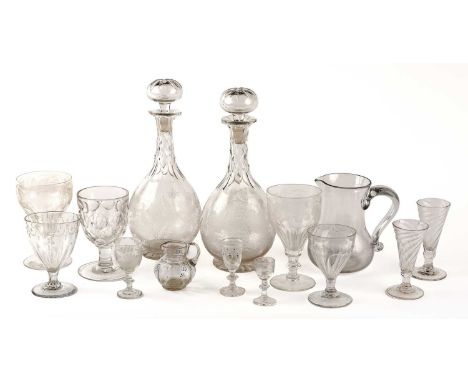A collection of Georgian and later glassware to include two decanters and three rummers some with engraved decoration the lar