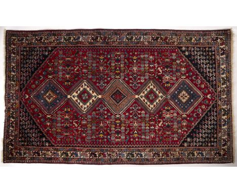 A modern Isfahan red ground rug with five central diamond motifs 150cm x 250cmSmall old areas of moth damage.  Snipped fringe