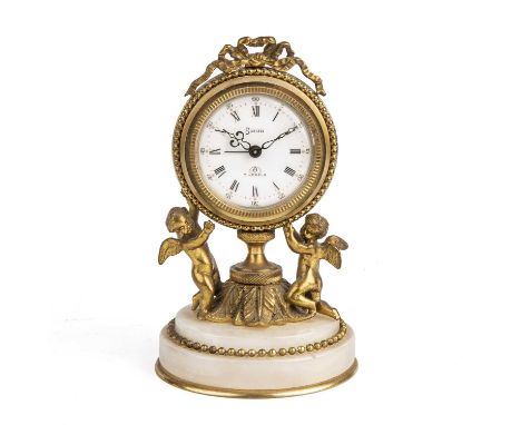 A Swiza 7 jewels alarm clock, retailed by Halcyon days London, with gilt cherubs and an onyx base 9cm wide 4.5cm high