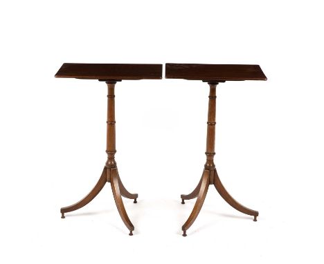 A near pair of Edwardian mahogany wine tables with rectangular tops a slender faux bamboo column standing on an outstretched 