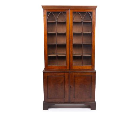 A 19th century mahogany bookcase with twin glazed doors above twin panel doors below all raised on bracket feet. 95cm wide 35