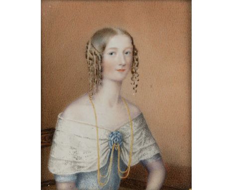 A late 18th or early 19th century miniature portrait of a lady in a blue dress, painted on ivory 9.5cm x 7.5cm mounted in a g