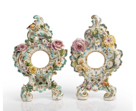 A near pair of mid 19th century Coalport porcelain flower encrusted pocket watch stands 15cm wide 23cm highBoth with hairline