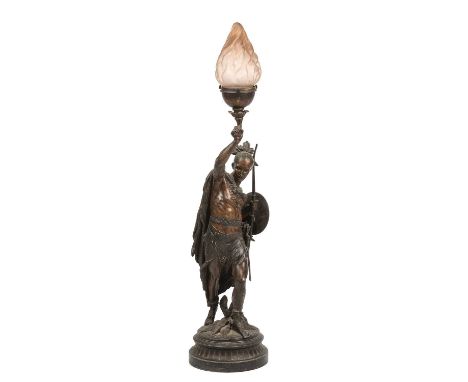  An antique patinated spelter lamp in the form of an American Indian holding a bow, having a frosted glass shade 95cm highNee