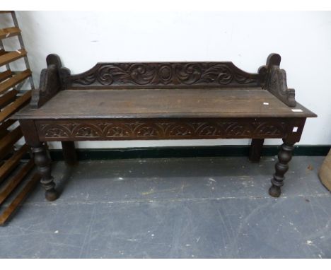 A CARVED OAK HALL BENCH. W 122 X D 37 X SEAT HEIGHT 45CMS. 