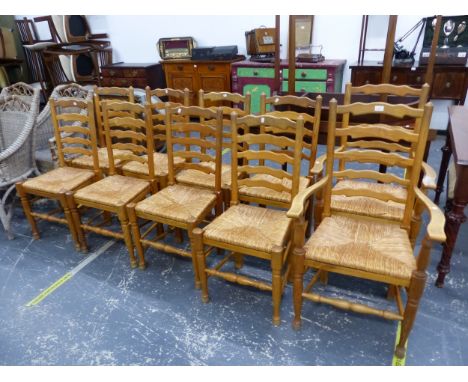 A SET OF TEN RUSH SEAT ELM LANCASHIRE LADDER BACK DINING CHAIRS, INC TWO CARVERS. 