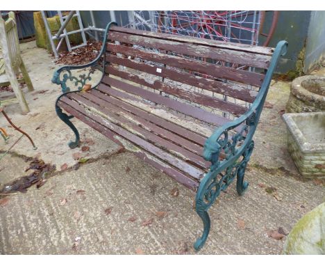 A GARDEN BENCH WITH CAST ENDS.
