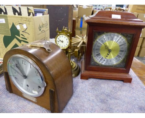 A BRASS ANNIVERSARY CLOCK, AN ART DECO MANTLE CLOCK, A MAHOGANY CASED BRACKET CLOCK AND A POWER WHEEL FROM A WATER CLOCK.