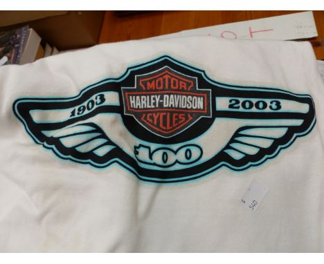 A COLLECTION OF HARLEY-DAVIDSON T SHIRTS AND RELATED BOOKS.