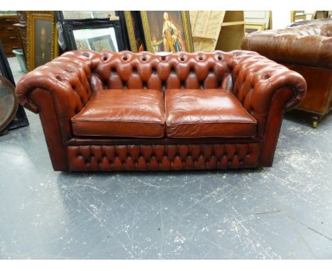 AN ORANGE TAN LEATHER UPHOLSTERED BUTTON BACK CHESTERFIELD SOFABED. W X 164 X D 92 X SEAT HEIGHT 44 X BACK HEIGHT 93 CMS.