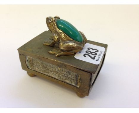 A novelty brass matchbox holder with brass and jade coloured stone frog mount.
(r6)