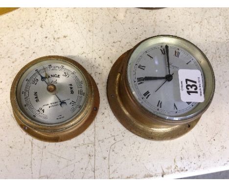 A small ship's barometer together with a brass cased ship's clock.