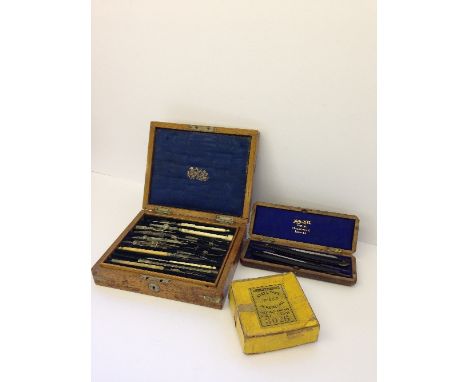 An early 20th century mahogany cased geometry drawing set together with a boxed set of two cut throat razors by Mappin & Webb