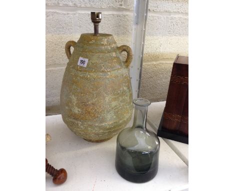 An Art Glass grey tinted bottle shaped vase together with an Art Pottery twin handled lamp base.